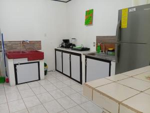 a kitchen with stainless steel appliances and a refrigerator at Apartamentos GoZu # 2 in Puerto Viejo
