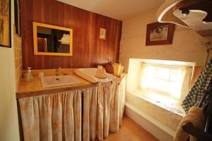 a bathroom with a sink and a window at Le Masbareau, Chambre et Table d'Hôtes de Charme, B&B in Royères-Saint-Léonard +29 photos