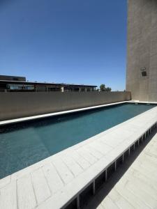 a swimming pool on the roof of a building at Brickell 3A in Tigre