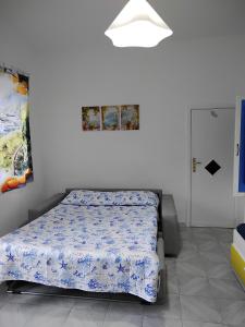 a bedroom with a bed in a white room at House Le Antiche Mura in Castel Volturno