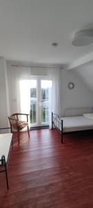 a room with two beds and a large window at Ferienhaus Vogelsberg in Mechernich