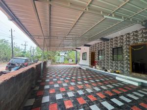 an empty garage with a car parked in a parking lot at Athityam Home Stay in Honāvar