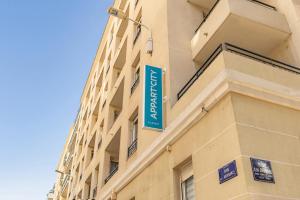 a blue sign on the side of a building at Appart'City Classic Lyon Part Dieu Garibaldi in Lyon