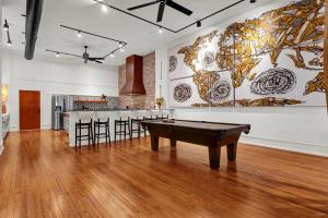 a room with a pool table in front of a wall at Luxe 220 Suite 6 in Wilmington