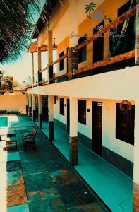 a building with a patio and a swimming pool at Pousada casa sonho do mar in Fortim