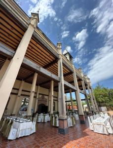 a pavilion with tables and chairs in front of a building at Hotel Castillo de Montemayor in Montemayor