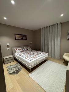a bedroom with a large bed and a window at Ciasa Enrico in Arabba