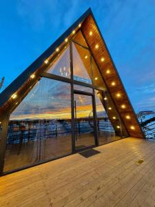 a large building with windows and lights on a boat at Canyon Resort in Yeghegnadzor +27 photos