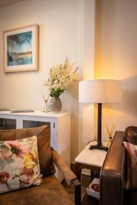 a living room with a chair and a lamp at Downshire Haven in Holywood