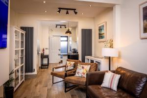 a living room with a couch and chairs and a table at Downshire Haven in Holywood