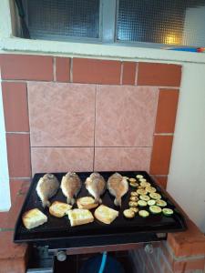 a grill with meat and vegetables on it at Apartments Orange Lovran in Lovran