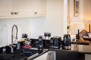 a kitchen with a sink and a counter top at Downshire Haven in Holywood +16 photos