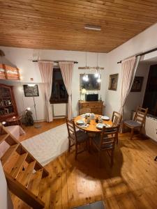 a dining room with a table and chairs at Romantický vejminek pod horami in Kounov