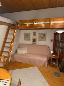 a bedroom with a bed in a room with stairs at Romantický vejminek pod horami in Kounov