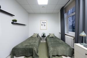 two beds in a room with a window at loond Stay- Kehra Ärimaja in Kekra