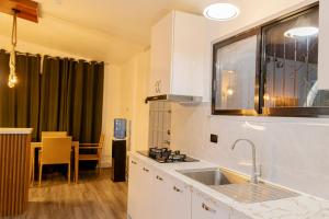 a kitchen with a sink and a window and a table at Casa Mutya in Dauis +24 photos
