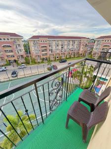 a balcony with two chairs and a view of a street at Arezzo Place Davao in Davao City