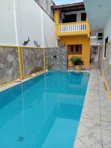 a swimming pool in the middle of a building at Pousada Bella Maré in Goiana