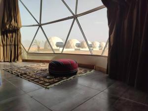 a room with a pillow on the floor in front of a window at Wadi rum camp in Wadi Rum