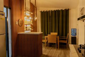 a dining room with a table and a green curtain at Casa Mutya in Dauis