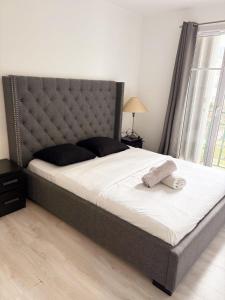 a bedroom with a large bed with a large headboard at Cosy home Disney in Two min in Chessy +11 photos
