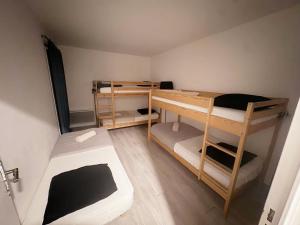 a small room with two bunk beds in it at Cosy home Disney in Two min in Chessy