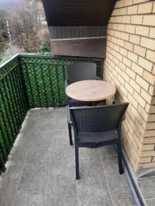 a wooden table and chairs sitting on a patio at Stars lux room in Belgrade