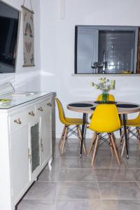 a kitchen with a table and yellow chairs at El Refugio de La Condesa Carmen in Manzanares +14 photos