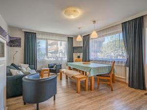 a living room with a table and a couch at Großvenediger in Mittersill