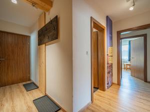 a hallway with a door and a room with wood floors at Großvenediger in Mittersill
