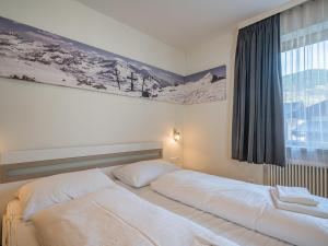 a bedroom with two beds and a window at Hohe Tauern in Mittersill