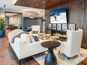 a living room with a white couch and a tv at Pioche Village Park City in Park City