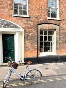 a bike parked on a sidewalk in front of a building at The Artist's House in Norwich