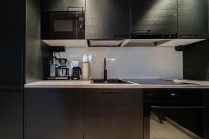 a kitchen with a sink and a counter top at Le Chalet Lingonberry D3 Ski-in Ski-out, Hot Tub by Aavalevi in Levi