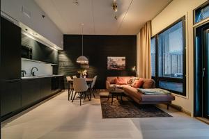 a living room with a couch and a table at Le Chalet Lingonberry D3 Ski-in Ski-out, Hot Tub by Aavalevi in Levi