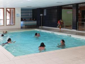 a group of children swimming in a swimming pool at Charmant 2 pièces pour 6 avec piscine, jacuzzi et sauna - Les Orres - FR-1-322-373 in Les Orres +8 photos