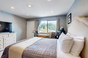 a bedroom with a large bed and a window at Sea Treasures Inn #101 in Rockaway Beach +18 photos