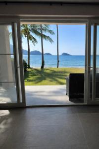 a view of the ocean from a room with a sliding glass door at Rosdao Beachfront Villa in Ban Khlong Son