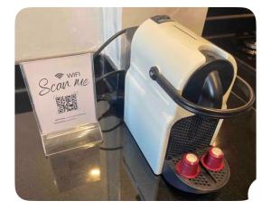 a toaster on a table with a sign next to it at Appartement avec vue sur parc et Wifi 100 Mo illimité ! in Fez +10 photos