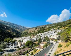 a view of a town in the mountains at El rincón de la Yaya in Pampaneira