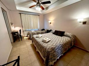 a bedroom with a bed and a ceiling fan at Patagonia Hotel in Caleta Olivia