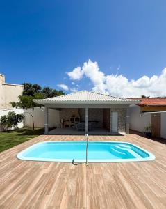 a swimming pool in front of a house at House in Jaconé in Maricá