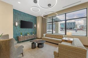 a living room with a couch and a tv at Drury Plaza Hotel Lincoln Downtown in Lincoln