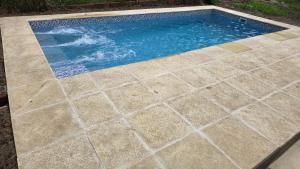 a pool with a tile floor and a swimming pool at Casa 12o - Paso de la Patria in Paso de la Patria