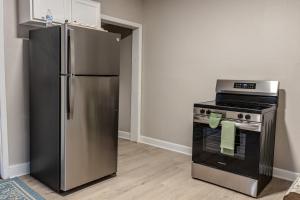a kitchen with a stainless steel refrigerator and an oven at The Heart house in Indianapolis