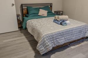 a bedroom with a large bed with towels on it at The Heart house in Indianapolis