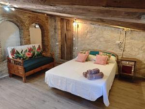 a bedroom with a bed and a chair at Estudio en masía Can Mon in Anglés