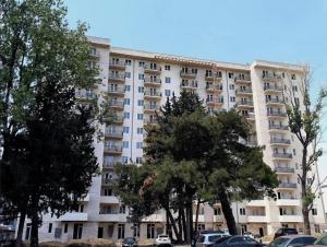 a large white apartment building with trees in front of it at E&L Apartment tbilisi in Tbilisi City