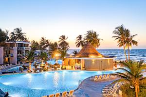 an image of a resort with a swimming pool and the ocean at Kombo Beach Resort in Serekunda