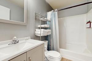 a bathroom with a sink and a toilet and a shower at Sea Treasures Inn #102 in Rockaway Beach